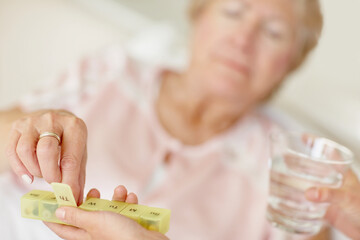 Nurse giving pill to senior woman