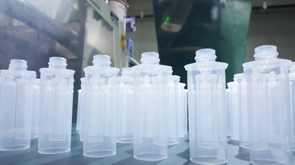  plastic bottles, on the background of injection molding machines. in the working line of the...
