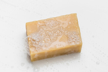 Soap bar and foam on white background, top view. Mockup for design