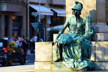Fragment of the monument-the figure of a warrior with a sword