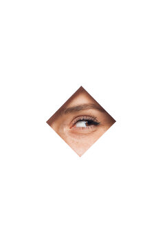Unrecognizable female with brown eyes looking through square shaped hole in white wall