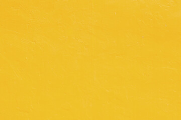 Vivid yellow stucco wall background. Yellow painted cement wall background texture.