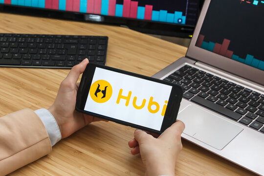 SAN FRANCISCO, US - 18 June 2019: Female Trader Hands Holding the Smartphone Using Application of HUBI Cryptocurrency Exchange Market. 