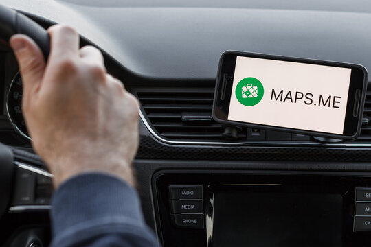 LOS ANGELES, CALIFORNIA - JUNE 6, 2019: Close up to male driving and using navigation appliction Maps Me. An illustrative editorial image