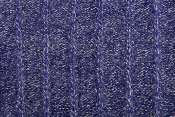 Background from dark blue and white woolen pile thread.Knitted structure pattern.Top view.Soft focus.Textured surface concept for decoration,design.