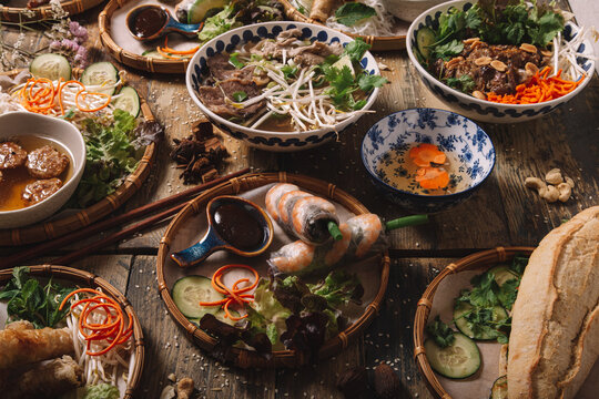 From above of assorted dishes of Vietnamese cuisine arranged on wooden table in luxury restaurant