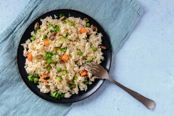Vegan rice with vegetables, healthy and delicious, shot from the top with a place for text