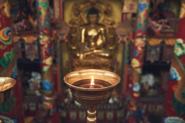 High angle of burning candle in candlestick lit for prayer in holy place in Buddhist temple in China