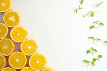 cut oranges on the table near mint leaves