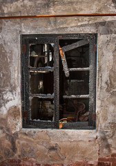 Wooden window of house after the fire. black wooden frame.