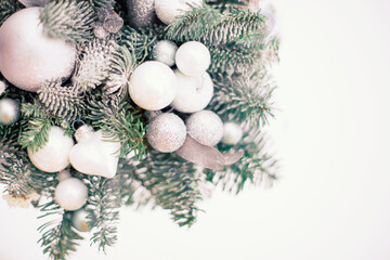 Fototapeta na wymiar Advent new year decoration with two silver candles and fir branches decorated with white glass balls and snow. Christmas background