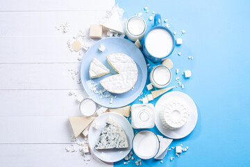 Dairy products on white wood  and blue background  with  copy space. Top view , flat lay. - obrazy, fototapety, plakaty
