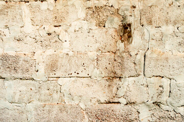 Texture of a brick wall with cracks and scratches which can be used as a background