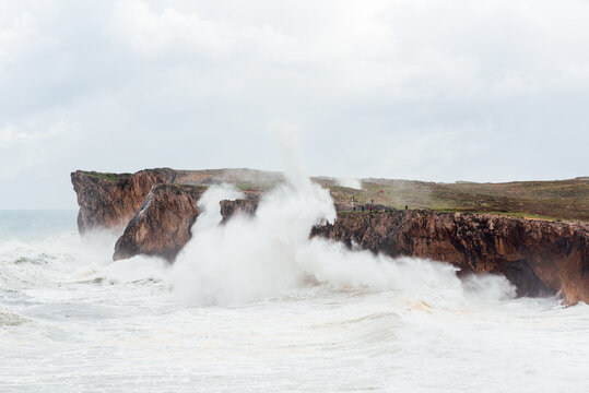 Spectacular scenery of foamy sea waving over rough rocky cliff on sunny day in Bufones de Llames Pr&radic;&ne;a in Spain
