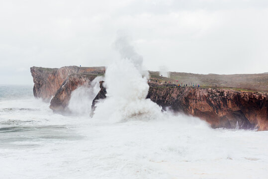 Spectacular scenery of foamy sea waving over rough rocky cliff on sunny day in Bufones de Llames Pr&radic;&ne;a in Spain