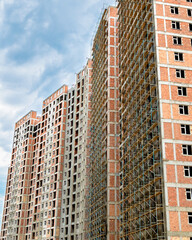 Fototapeta premium High buildings with scaffold at the construction site