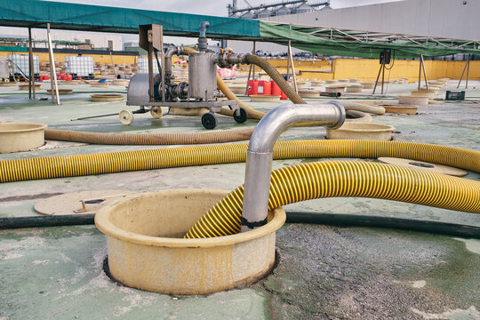 Metal construction with water and pipes placed in industrial area with tanks for purification of raw material at factory
