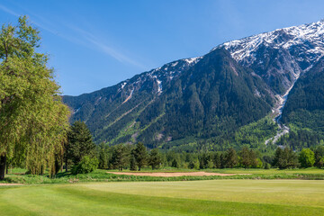 Fototapeta na wymiar Golf course with gorgeous green and fantastic montain view.