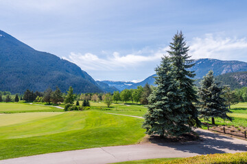 Fototapeta na wymiar Golf course with gorgeous green and fantastic montain view.