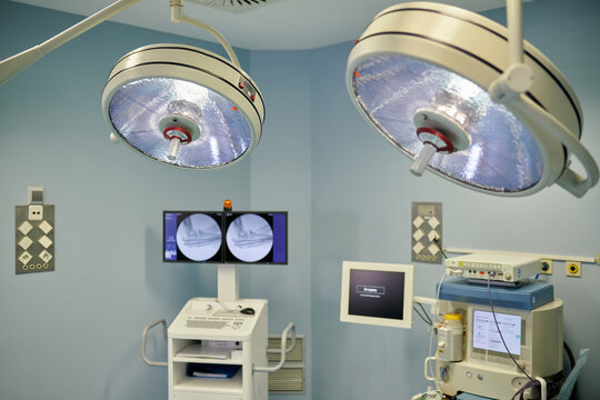 Spacious operating room with contemporary medical equipment and surgical headlights in modern hospital