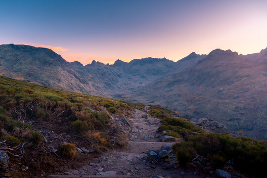 Scenery view of shabby path between moss in mounts under colorful sky at sundown in Sierra de Gredos