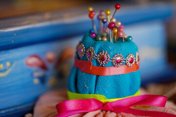 Needles in a pincushion shaped as a hat