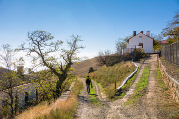 A tourist walks past the house of the lighthouse keeper in the Republic of Crimea