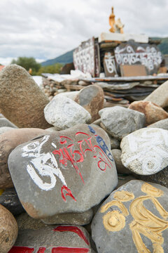 Prayer stones placed in heap near oriental shrine in green Sichuan province in China