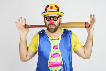 The clown is a man in a bright blue and yellow suit with a baseball bat.