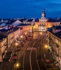 Naklejka premium Aerial view of colorful tenement houses and town hall at night in Old Town in Lublin, Poland