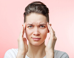 Young beautiful woman has headache.Isolated on red background. Close Up.