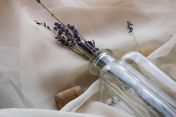 Fototapeta na wymiar lavender bouquet in a glass bottle or vase on a light background, top view