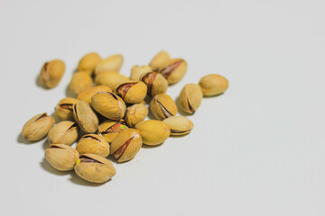 a handful of pistachios that lie on a white background