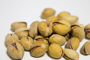 a handful of pistachios that lie on a white background