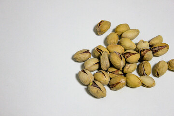 a handful of pistachios that lie on a white background