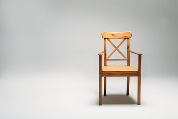 Classical wooden chair isolated against gray background