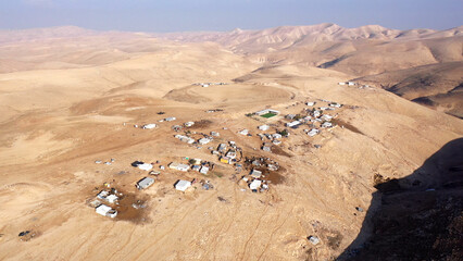 Fototapeta na wymiar Bedouin camp Isolated in Judaean desert Aerial view Drone footage over Bedouin outpost Close to Israeli City Maale Adumim Aerial, Israel 