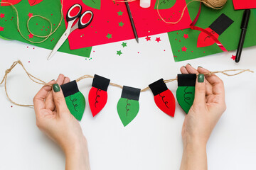 How easy and quick make paper Christmas red and green light bulb garland to decorate room or tree with children at home. Step by step instructions. Step 10. Make some light bulbs and use ready garland