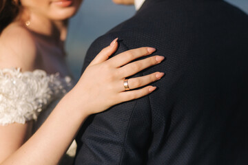 Close-up of Bride hug groom. Photo of hands