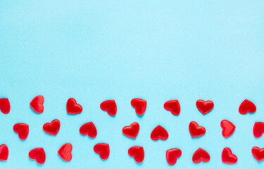 Red small hearts on a pastel blue background, horizontal orientation, copy space