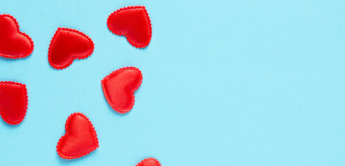 Festive banner for Valentine's Day, hearts close-up on a blue background, horizontal orientation, copy space