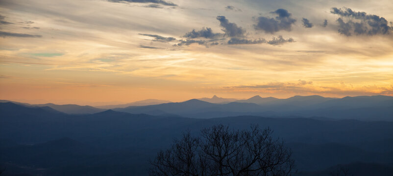 Sunset in winter in the Applachain Mountains, vivid sky with orange hues and layers of smoky blue mountains