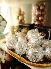 Christmas balls. Christmastime, happy new year concept. Golden christmas decoration on beige background.