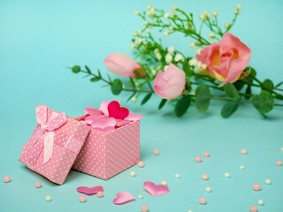 Gift pink box with hearts and flowers. Festive concept for Valentine's Day, Mother's Day or Birthday.
