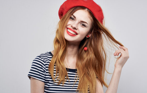 Attractive woman in a red beret and in a striped T-shirt beautiful smile model