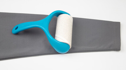 sticky plastic roller for cleaning clothes from dust, lint and hair