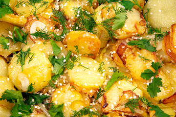cooked fried potatoes with herbs, spices and vegetables
