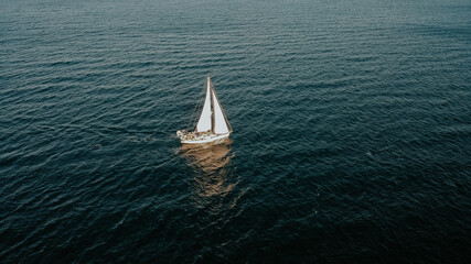  Aerial shot of lonely sailing boat at holiday on Saronic Gulf during sunset in Greece.