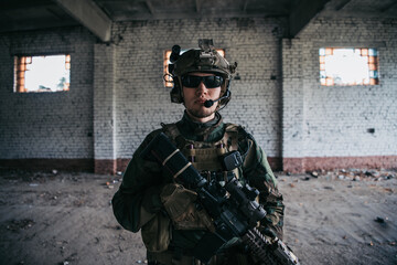 Close-up of a professional fully equipped soldier looking at camera.