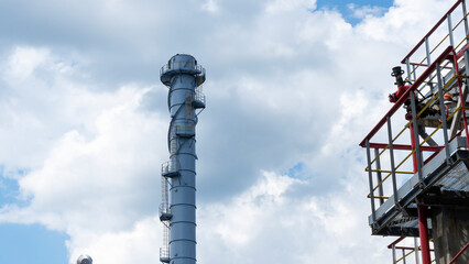 Industrial furnace and heat exchanger cracking hydrocarbons in factory on blue sky background, Close-up of equipment in petrochemical plant. Industry and ecological problem concepts.